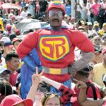 Deserved Adulation: A supporter dressed as ‘Super Bigote/Super Moustache’ a joyful reference to Nicolas Maduro’s ‘stash’ - the cartoon superhero appeared at a campaign rally in Caracas, Venezuela, July 18 2024 Photo: Ariana Cubillos/AP Photo.