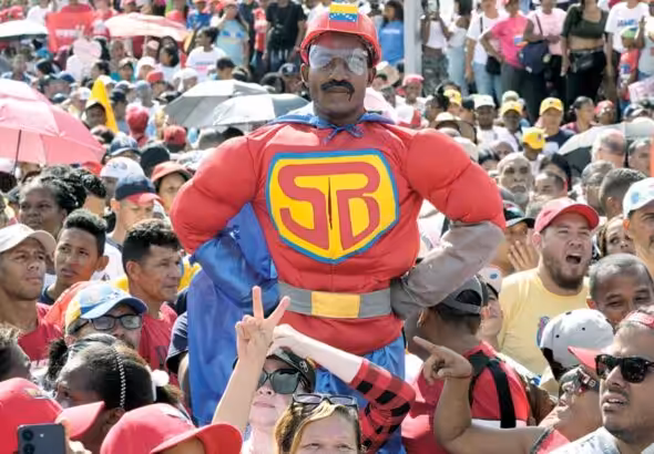 Deserved Adulation: A supporter dressed as ‘Super Bigote/Super Moustache’ a joyful reference to Nicolas Maduro’s ‘stash’ - the cartoon superhero appeared at a campaign rally in Caracas, Venezuela, July 18 2024 Photo: Ariana Cubillos/AP Photo.