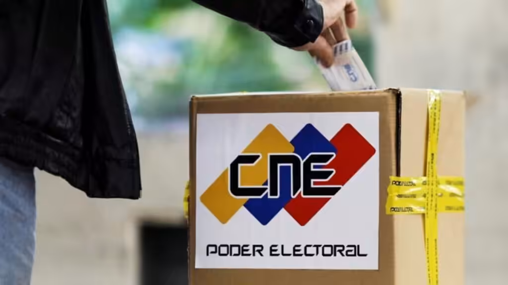Person casting a paper ballot in a box with the logo of the Venezuelan National Electoral Council (CNE). Photo: File photo.