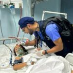 A US doctor treats a child at the European General Hospital in Khan Younis, Gaza. Photo: Usman Shah/Dawn.
