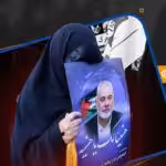 A woman holds a picture of martyred Hamas leader Ismail Haniyeh. Photo: Al-Mayadeen.