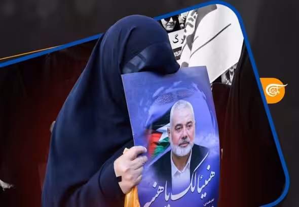 A woman holds a picture of martyred Hamas leader Ismail Haniyeh. Photo: Al-Mayadeen.