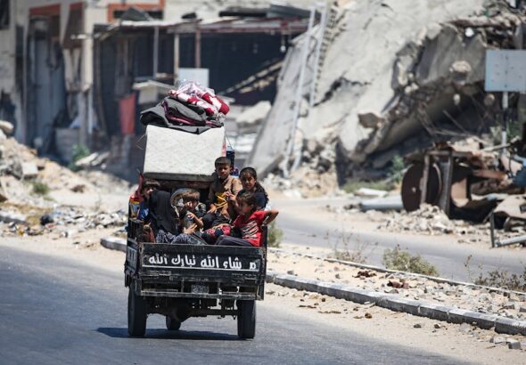 Children sit in the back of a small vehicle as Palestinians flee with their belongings from Deir el-Balah in the central Gaza Strip on August 16, 2024. Photo: AFP.