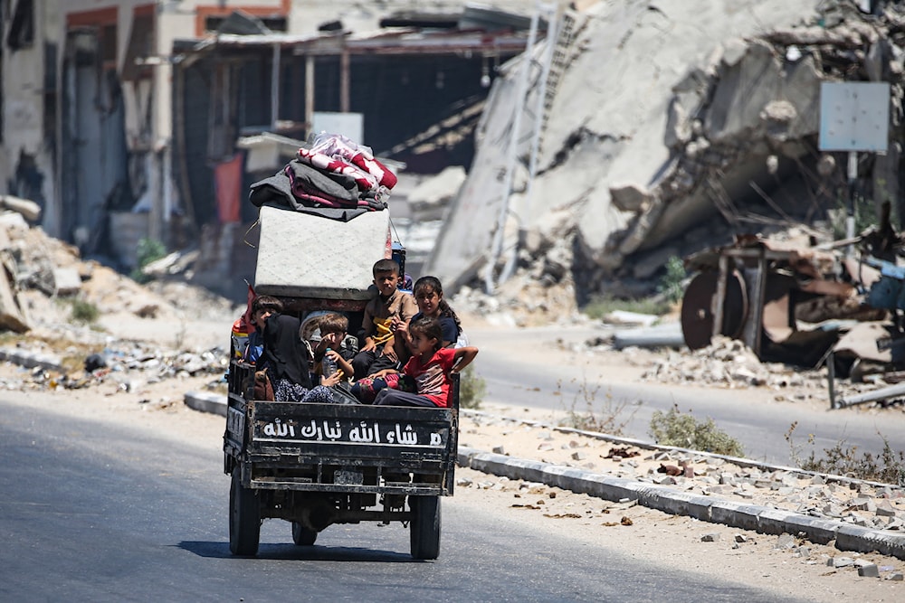 Children sit in the back of a small vehicle as Palestinians flee with their belongings from Deir el-Balah in the central Gaza Strip on August 16, 2024. Photo: AFP.