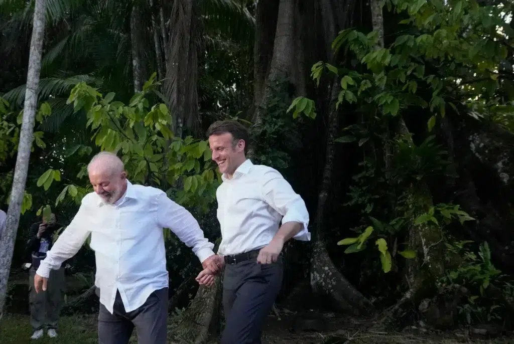 Brazilian President Luiz Inácio Lula da Silva and French President Emmanuel Macron holding hands while visiting Combu Island, Brazil, on March 26. Photo: Eraldo Peres/AP/file photo.