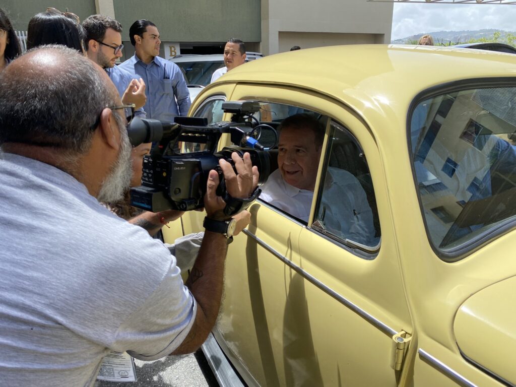 Former far-right presidential candidate Edmundo Gonzalez, posing for a photo from inside a German yellow Volkswagen Beetle, during a photo shoot for his presidential campaign. Photo: X/@rohernandezm_.