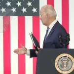 US President Joe Biden appearing to reach out for a handshake, despite nobody being on stage with him. Thursday, April 14, 2022. Photo: WFMY/File photo.