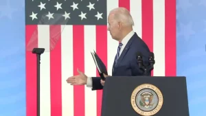 US President Joe Biden appearing to reach out for a handshake, despite nobody being on stage with him. Thursday, April 14, 2022. Photo: WFMY/File photo.