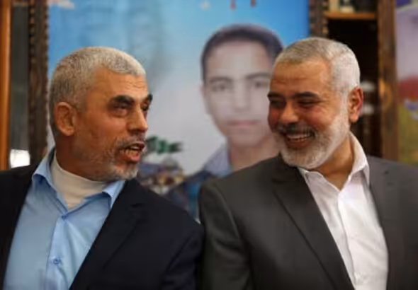 Yahya Sinwar, the head of the Hamas political bureau, laughs alongside martyred Hamas Leader Ismail Haniyeh. Undated. Photo: Social Media.