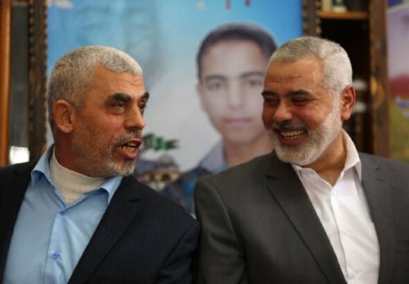 Yahya Sinwar, the head of the Hamas political bureau, laughs alongside martyred Hamas Leader Ismail Haniyeh. Undated. Photo: Social Media.