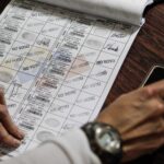 CNE election notebook being filled with a “did not vote” stamp after an election. Photo: EFE/file photo.