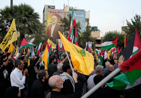 Iranian protesters wave Iranian, Palestinian, and Hezbollah group flags in a demonstration to condemn the killing of Hamas leader Ismail Haniyeh, at Felestin (Palestine) Sq. in Tehran, Iran, Wednesday, July 31, 2024. Photo: AFP.