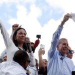 Far-right politician Maria Corina Machado and her candidate Edmundo Gonzalez hold their alleged voting records as they address a small group of supporters, in Caracas, Venezuela on July 30, 2024. Photo: Alexandre Meneghini/Reuters.