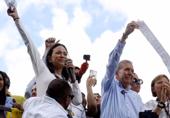 Far-right politician Maria Corina Machado and her candidate Edmundo Gonzalez hold their alleged voting records as they address a small group of supporters, in Caracas, Venezuela on July 30, 2024. Photo: Alexandre Meneghini/Reuters.