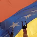 Kids playing below a giant Venezuelan flag. File photo.