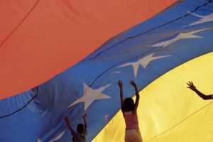Kids playing below a giant Venezuelan flag. File photo.