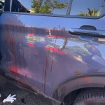 A police officer inspects a car in which a hand-held pager exploded, in Beirut, Lebanon. Photo: Hussein Malla.