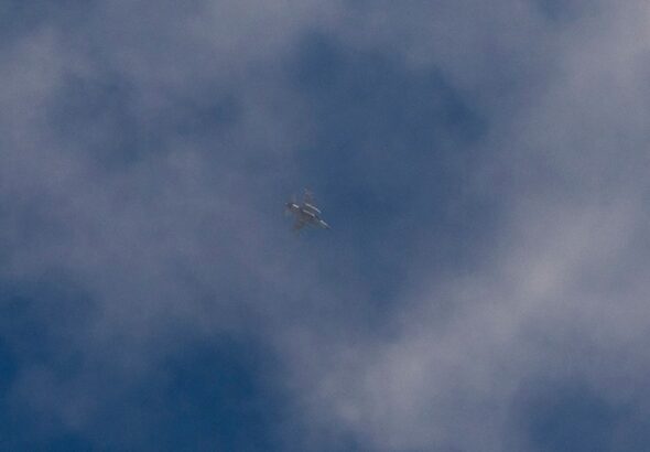 An armed 'Israeli' fighter jet flies over Haifa, northern occupied Palestine. Photo: AP.