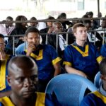 Along the back row shows from left; Benjamin Reuben Zalman-Polun, Marcel Malanga, and Tyler Thompson, all American citizens, attend a court verdict in Congo, Kinshasa, Friday, Sept. 13, 2024, on charges of taking part in a coup attempt in May 2024. Photo: Al Mayadeen.