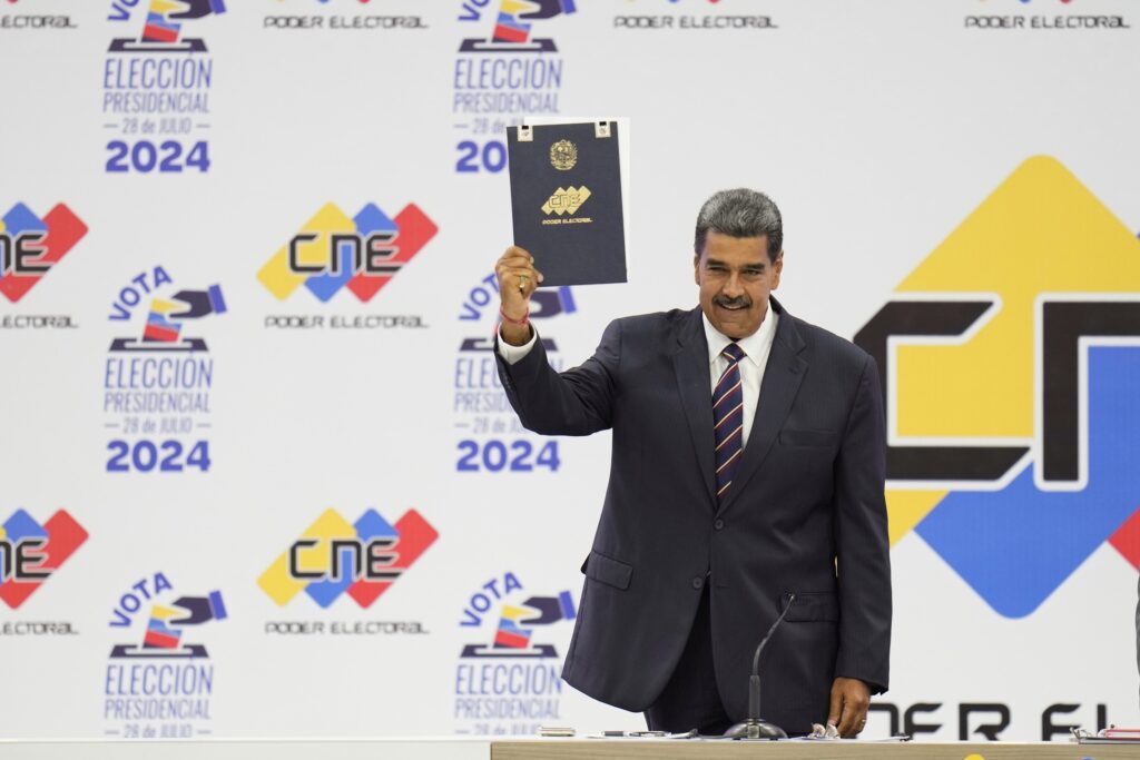 Venezuelan President Nicolas Maduro holds up his certification from the National Electoral Council (CNE) that declares him the winner of the presidential election, at the CNE in Caracas, Venezuela, July 29, 2024. Photo: Matias Delacroix/AP/file photo.