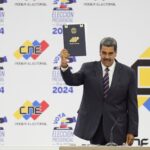 Venezuelan President Nicolas Maduro holds up his certification from the National Electoral Council (CNE) that declares him the winner of the presidential election, at the CNE in Caracas, Venezuela, July 29, 2024. Photo: Matias Delacroix/AP/file photo.