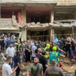 People gather near a damaged building at the scene of an Israeli missile strike in the Southern Suburb of Beirut on Friday, September 20, 2024. Photo: AP.