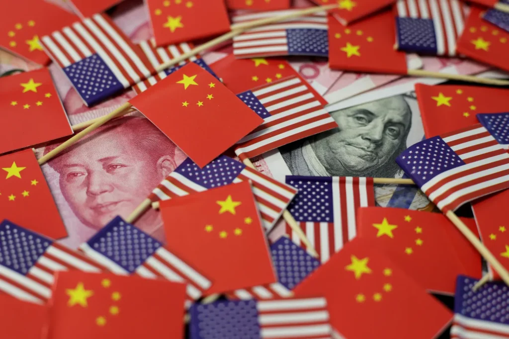 Chinese and US flags and currency notes. File photo.