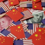 Chinese and US flags and currency notes. File photo.