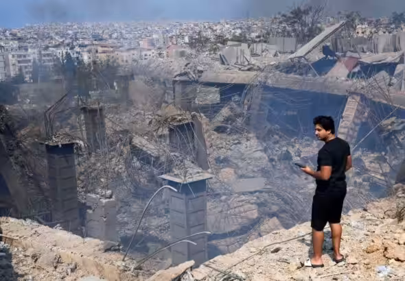 A person looking at the destruction in the place where Hezbollah Secretary-General Hassan Nasrallah was assassinated in Choueifat, southeast of Beirut, Lebanon. Photo: AP.