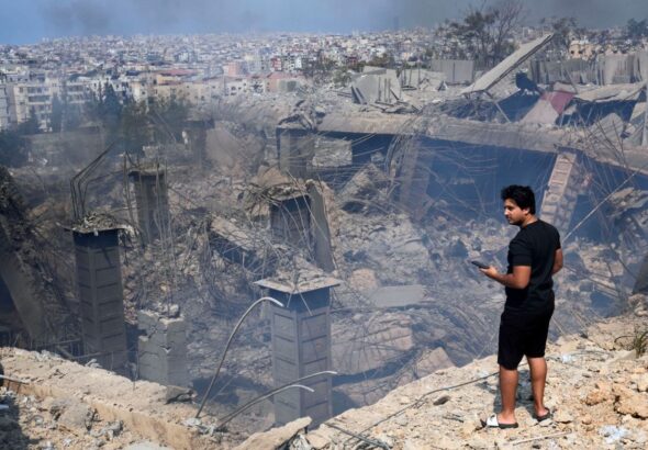 A person looking at the destruction in the place where Hezbollah Secretary-General Hassan Nasrallah was assassinated in Choueifat, southeast of Beirut, Lebanon. Photo: AP.