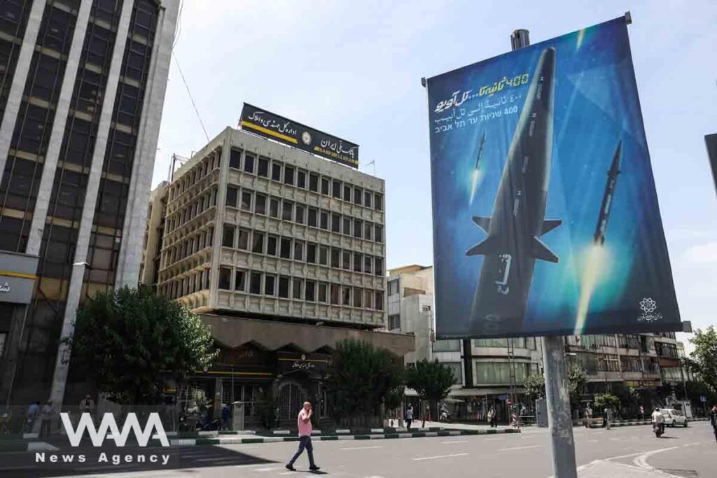 A banner with a photo of an Iranian hypersonic ballistic missile named "Fattah" with a caption reading "400 seconds to Tel Aviv," as seen in a street in Tehran, Iran June 8, 2023. Photo: Majid Asgaripour/WANA/file photo.