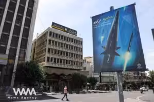 A banner with a photo of an Iranian hypersonic ballistic missile named "Fattah" with a caption reading "400 seconds to Tel Aviv," as seen in a street in Tehran, Iran June 8, 2023. Photo: Majid Asgaripour/WANA/file photo.