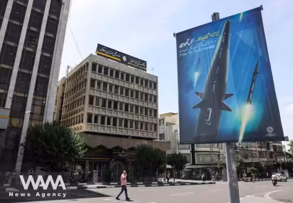 A banner with a photo of an Iranian hypersonic ballistic missile named "Fattah" with a caption reading "400 seconds to Tel Aviv," as seen in a street in Tehran, Iran June 8, 2023. Photo: Majid Asgaripour/WANA/file photo.