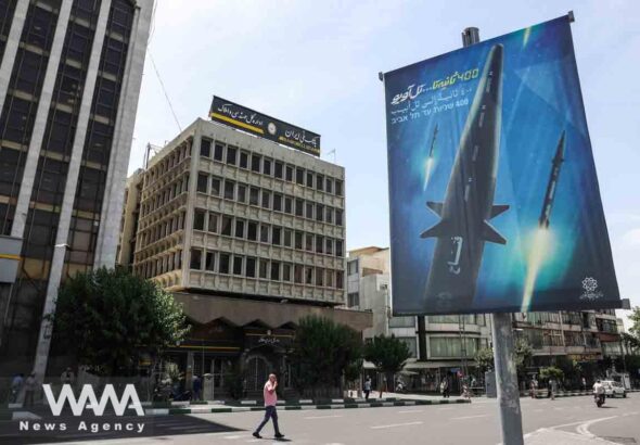 A banner with a photo of an Iranian hypersonic ballistic missile named "Fattah" with a caption reading "400 seconds to Tel Aviv," as seen in a street in Tehran, Iran June 8, 2023. Photo: Majid Asgaripour/WANA/file photo.