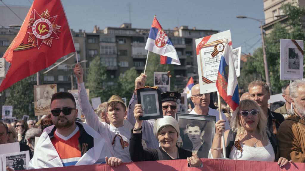People carry portraits of World War II soldiers during the 'Immortal Regiment' march on May 9, 2022 in Belgrade, Serbia. Photo: Vladimir Zivojinovic /Getty Images