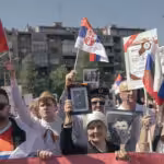 People carry portraits of World War II soldiers during the 'Immortal Regiment' march on May 9, 2022 in Belgrade, Serbia. Photo: Vladimir Zivojinovic /Getty Images