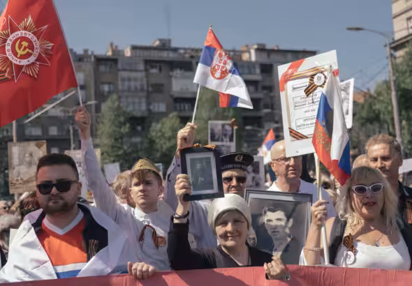 People carry portraits of World War II soldiers during the 'Immortal Regiment' march on May 9, 2022 in Belgrade, Serbia. Photo: Vladimir Zivojinovic /Getty Images