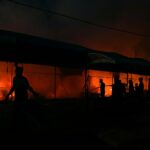 Palestinians try to extinguish a fire caused by Israeli airstrikes on tents in the courtyard of Al-Aqsa Martyrs Hospital, Deir al-Balah, central Gaza Strip, October 14, 2024. Photo: AP.