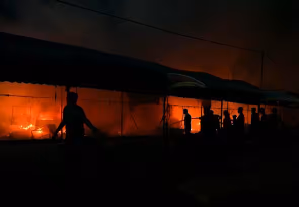 Palestinians try to extinguish a fire caused by Israeli airstrikes on tents in the courtyard of Al-Aqsa Martyrs Hospital, Deir al-Balah, central Gaza Strip, October 14, 2024. Photo: AP.