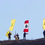 Resistance fighters stand with flags of Hezbollah and Lebanon. Photo: Social media.