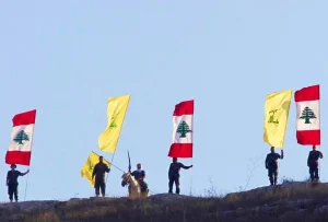 Resistance fighters stand with flags of Hezbollah and Lebanon. Photo: Social media.