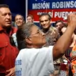 Venezuelan President Hugo Chávez interacting with a Venezuelan woman that learned to write and read thanks to the Bolivarian Revolution back in 2005.  File photo.