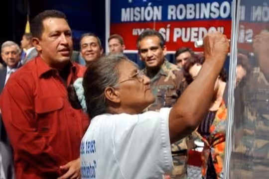 Venezuelan President Hugo Chávez interacting with a Venezuelan woman that learned to write and read thanks to the Bolivarian Revolution back in 2005.  File photo.