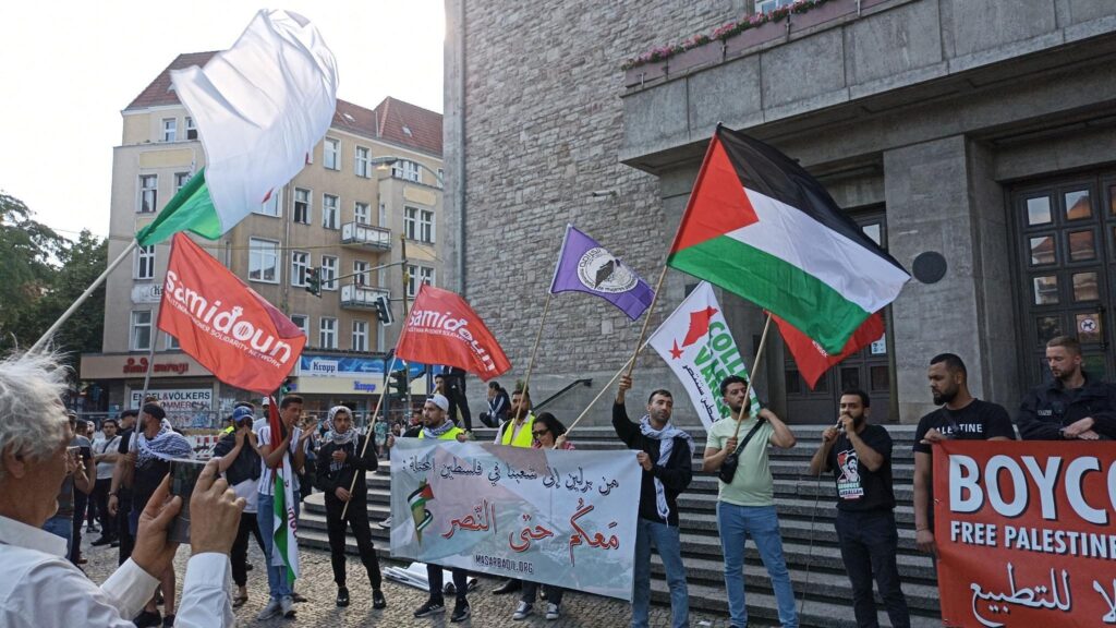 Pro-Palestine activists in Berlin march with flags of Palestine and Samidoun. Photo: X/@SamidounPP.