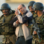 FARC leader Ricardo Palmera, better known as Simón Trinidad, brought to Bogota, Colombia after his capture in Ecuador, January 2004. Photo: Miguel Menéndez/EPA/Corbis/file photo.