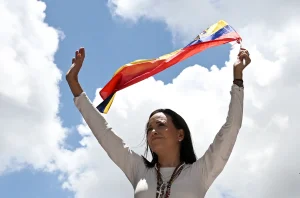 Far-right opposition politician María Corina Machado with a Venezuelan flag at a rally, on August 28, 2024, in Caracas. Photo: Juan Barreto/AFP/File photo.