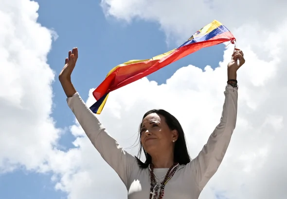 Far-right opposition politician María Corina Machado with a Venezuelan flag at a rally, on August 28, 2024, in Caracas. Photo: Juan Barreto/AFP/File photo.