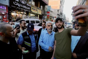 Yahya Sinwar, the leader of Hamas who was killed in combat with Israeli occupation forces in Gaza on 16 October 2024, greets supporters as he tours Gaza City’s al-Rimal neighborhood on 26 May 2021, to assess the damage from Israeli bombing. Photo: Ashraf Amra/APA images.