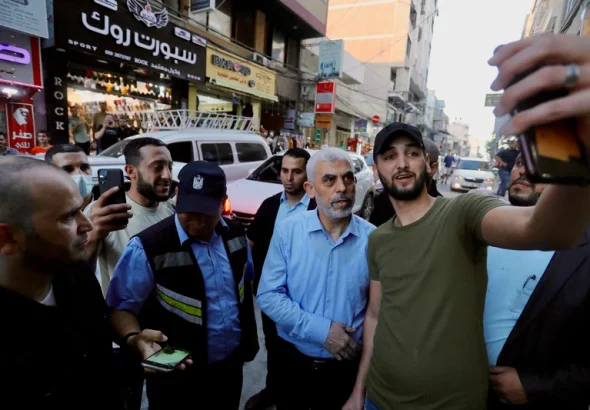Yahya Sinwar, the leader of Hamas who was killed in combat with Israeli occupation forces in Gaza on 16 October 2024, greets supporters as he tours Gaza City’s al-Rimal neighborhood on 26 May 2021, to assess the damage from Israeli bombing. Photo: Ashraf Amra/APA images.