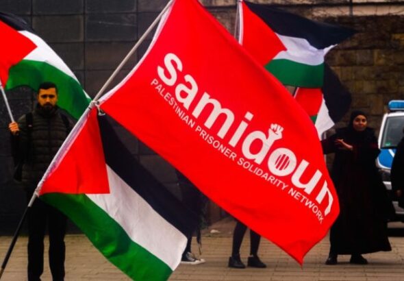 Dozens of protesters from the Samidoun organization gathering in front of the Muelheim train station in Cologne, Germany, on April 15, 2023, to commemorate Palestinian Prisoners’ Day. Photo: Ying tang/Nurphoto via zuma press apaimages.